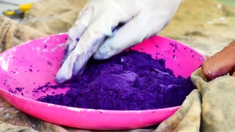 How to make colored powder, holi Festival. The hands are salting food colorin Stock Footage 83473426