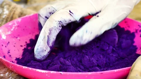 How to make colored powder, holi Festival. The hands are salting food colorin Stock Footage 83473446