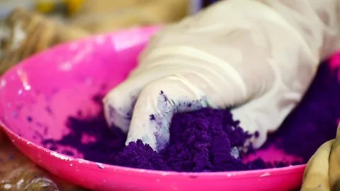 How to make colored powder, holi Festival. The hands are salting food colorin Stock Footage 83473457