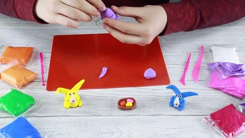 How to make an Easter bunny out of plasticine. Step 2 Stock Footage 148530706