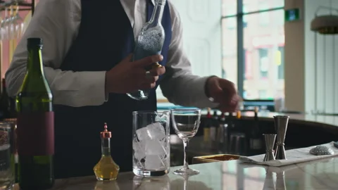 How to make a Martini Part 3 of 7: A bartender adds gin into his perfect martini Stock Footage 199457894