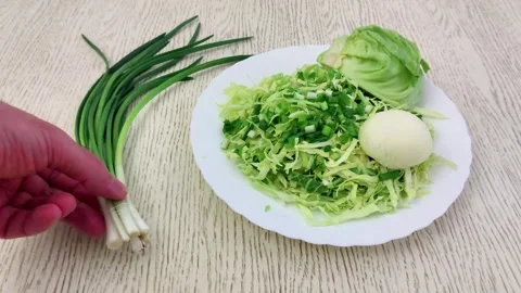 How to Make a Refreshing Spring Cabbage and Green Onion Salad Video stock 327357630