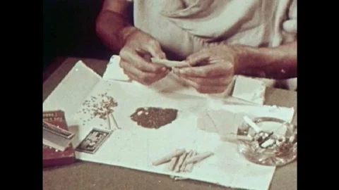 How marijuana joints are rolled is discussed in this 1951 drug education film. Stock Footage 106906586