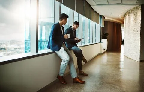 How professionals hit the pause button. a young businessman using a digital Stock Photos