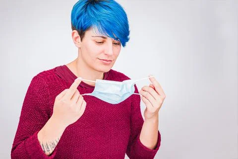 How to put a COVID-19 mask. Woman with Coronavirus breath mask Stock Photos