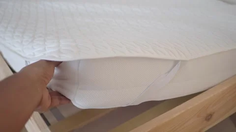How to put a mattress cover on a bed Stock Footage 329598156