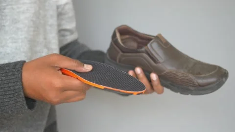 How to replace insoles in comfortable shoes for better support Stock Footage 305620314
