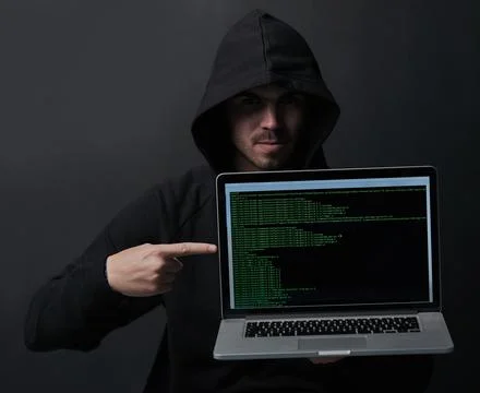 How secure is your laptop really. Portrait of an unidentifiable computer hacker Foto stock