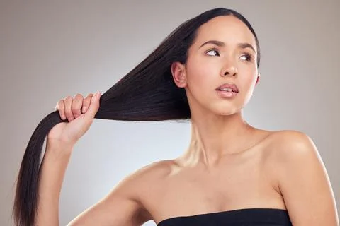 How should I do my hair today. an attractive young woman posing alone in the Stock Photos