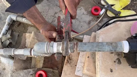 How to Tighten Water Pump Pipe Connections Using a Pipe Wrench Video stock 345611790