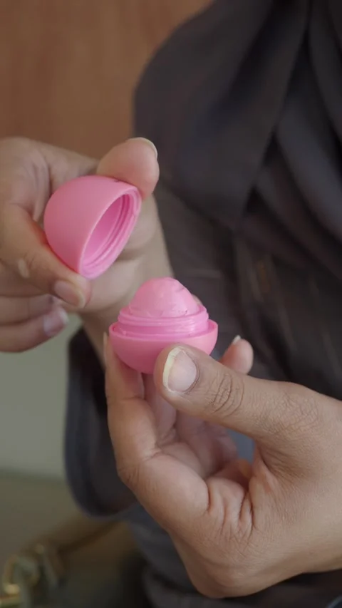 How to use a pink lip balm with ease Stock Footage 326576910