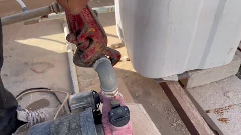 How to Use a Pipe Wrench to Tighten Plumbing Elbow Fittings Video stock 345611712