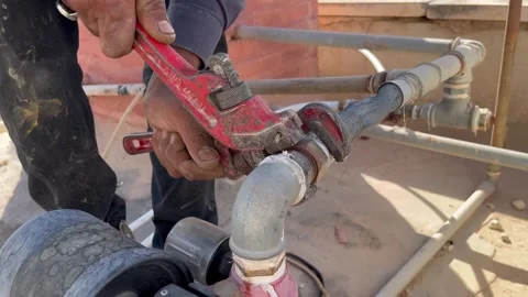 How to Use a Pipe Wrench to Tighten Plumbing Elbow Fittings Video stock 345611728