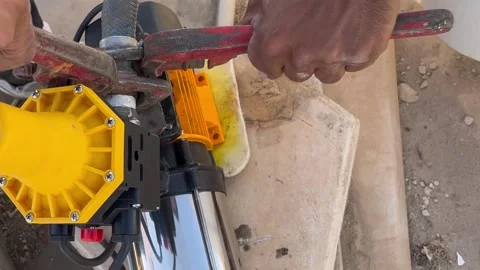 How to Use a Pipe Wrench to Tighten Plumbing Elbow Fittings Video stock 345740894