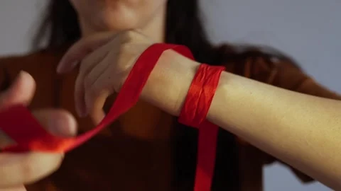 How to wrap ribbon around hand Stock Footage 245011343