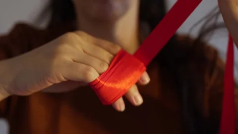 How to wrap ribbon around hand Stock Footage 245011382