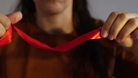 How to wrap ribbon around hand Stock Footage 245011383