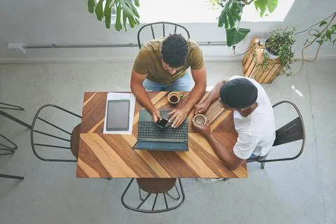 Hows this for an app idea. High angle shot of two unrecognizable friends sitting Stock Photos