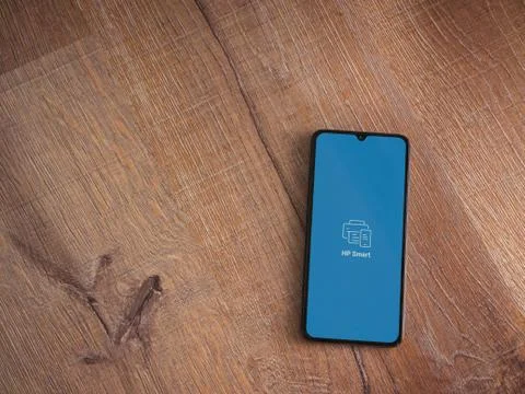 HP Smart app launch screen with logo on the display of a black mobile smartph Stock Photos