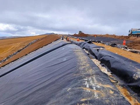 HPDE geomembrane installation process on mine Stock Photos