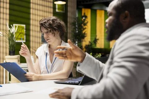 HR admin conducting a job interview with a black hopeful candidate Stock Photos