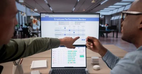 HR Manager And Employee Using Software Tools For Performance Review Discussio Stock Photos
