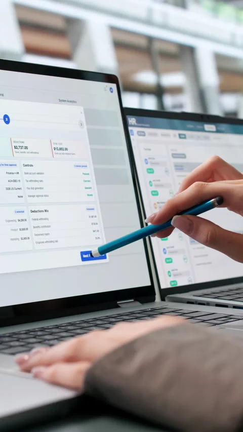 HR Manager Carefully Reviews Payroll Software Data On Laptop Stock Footage 345330879