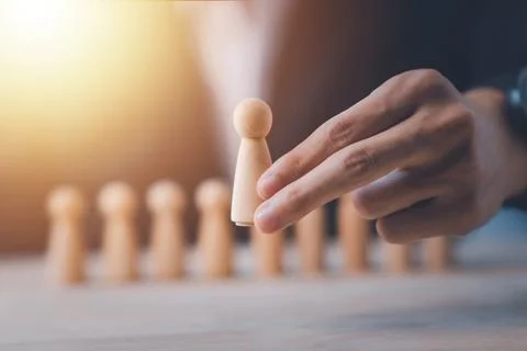 HR manager (human resources) or Employer hand choose takes person wooden do.. Stock Photos