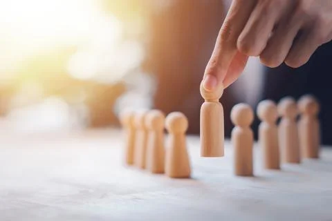 HR manager (human resources) or Employer hand choose takes person wooden do.. Stock Photos
