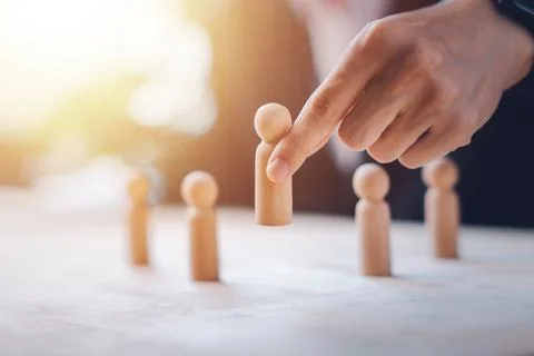 HR manager (human resources) or Employer hand choose takes person wooden do.. Stock Photos