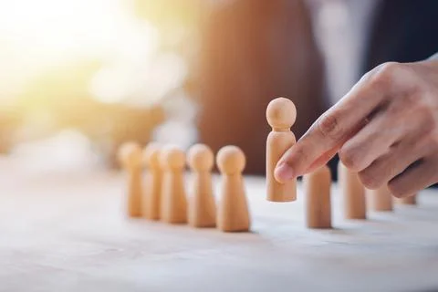 HR manager (human resources) or Employer hand choose takes person wooden do.. Stock Photos