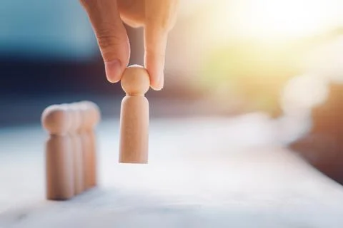 HR manager (human resources) or Employer hand choose takes person wooden do.. Stock Photos