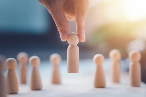 HR manager (human resources) or Employer hand choose takes person wooden do.. Stock Photos