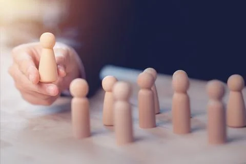 HR manager (human resources) or Employer hand choose takes person wooden do.. Stock Photos