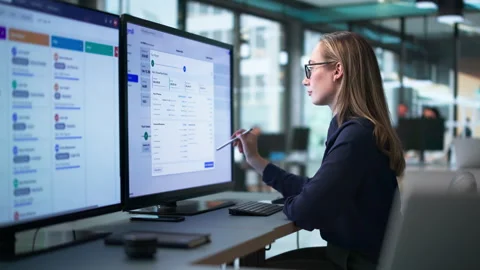 HR Manager Reviewing Payroll Data On Computer Stock Footage 339900728