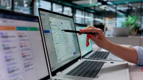 HR Manager Reviewing Payroll Software Data On Laptop Stock Footage 339171273