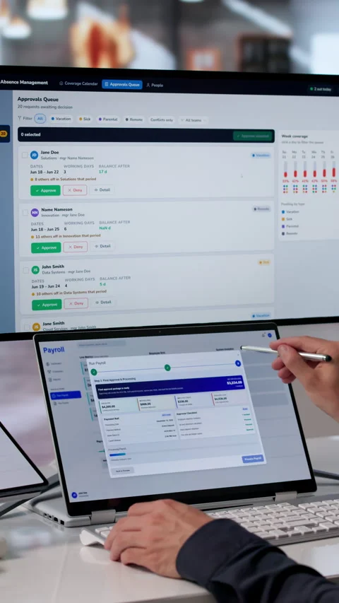 HR Manager Reviews Payroll Software On Dual-screen Laptop Stock Footage 340998023