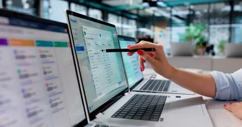 HR Manager Reviews Payroll Software On Laptop For Accurate Salary Processing. Stock Photos