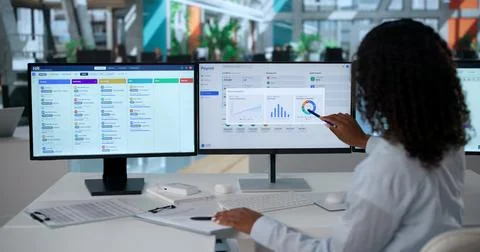 HR Manager Uses Computer Software To Check Employee Payroll And Benefits Stock Photos