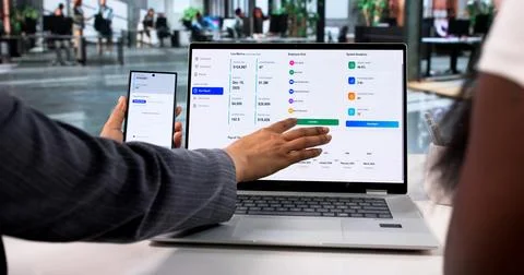 HR Managers Collaborate Using Laptop And Smartphone To Process Payroll Effici 스톡 사진