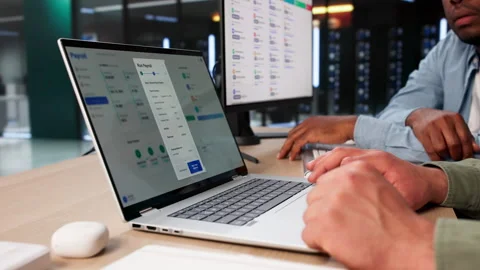HR Managers Reviewing Payroll Software Data Stock Footage 336370228