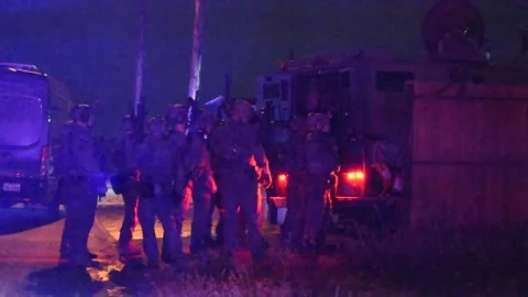 HSI Special Response Team armed and prepared during arrest warrant Stock Footage 300344805