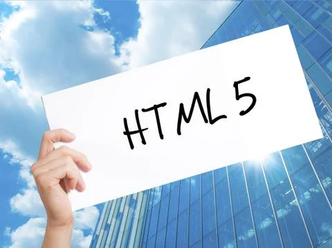 HTML 5 Sign on white paper. Man Hand Holding Paper with text. Isolated on Sky 写真素材