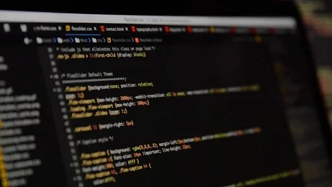 HTML and CSS code developing. Website design code programming on a laptop screen Stock Footage 77630294