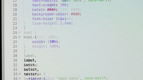 HTML and CSS code developing. Website design code programming on a laptop screen Stock Footage 77652760