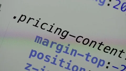 HTML and CSS code developing. Website design code programming on a laptop screen Stock Footage 77676908