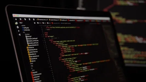 HTML and CSS code developing. Website design code programming on a laptop screen Stock Footage 77680417