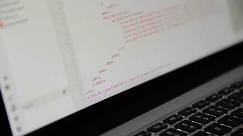 HTML and CSS code developing. Website design code programming on a laptop screen Stock Footage 77681442