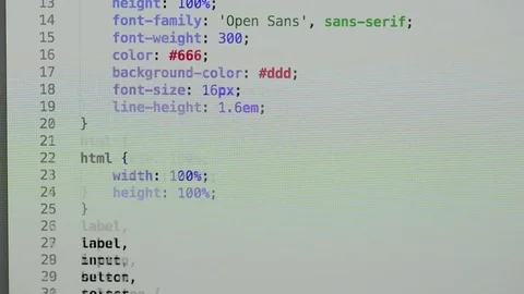 HTML and CSS code developing. Website design code programming on a laptop screen Stock Footage 77729838