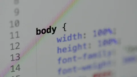HTML and CSS code developing. Website design code programming on a laptop screen Stock Footage 77729958
